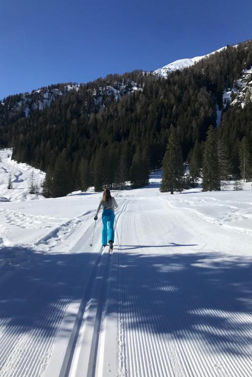 Una ragazza con tuta azzurra sta facendo una lezione di sci di fondo sulla pista del Gaver non lontano da Brescia