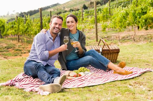 In un vigneto dell'Oltrepò Pavese in Lombardia una coppia sta facendo un picnic con degustazione di vino