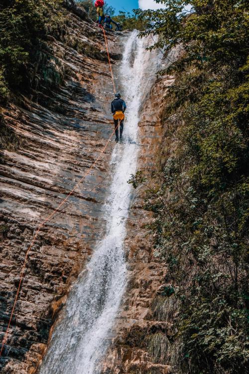 Calata in corda di gruppo durante l'esperienza di canyoning lungo il fiume Vione vicino al Lago di Garda in Lombardia.